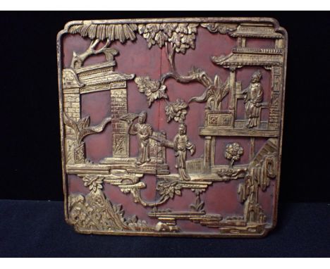 A CHINESE CARVED, PAINTED AND GILT WOOD PANEL Figures in an architectural setting 28 x 28cm