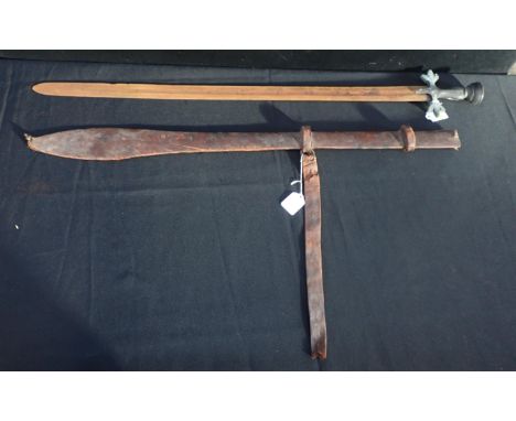 A 19th CENTURY SUDANESE/NORTH AFRICAN SWORD WITH BRASS HILT with fleur de lys form guard and cup shaped pommel, in leather sc