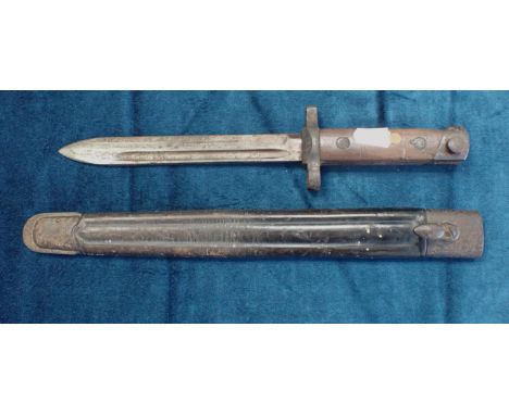 AN OLD BRITISH BAYONET hilt marked G24845 Calcutta, 29cm long, the associated scabbard marked G. Onutti 1942