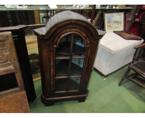 A George II style walnut dome top free standing corner cabinet the panel glazed door with key and painted interior over brack