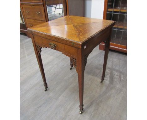 An Edwardian oak envelope card table with pierced brackets under. 55.5 x 55.5cm