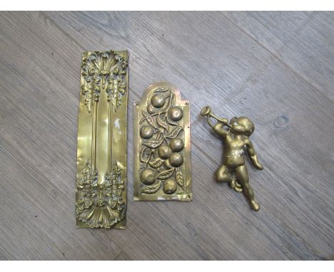 Two various brass finger plates and a door-knocker as a cherub playing a horn (worn) (3)