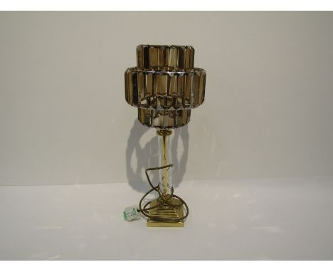 A modern electric table lamp with brass column evcased by cut glass on a stepped square brass base, with integral shade of sm