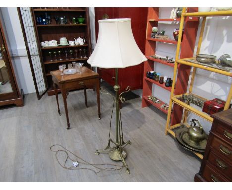 An Art Nouveau brass telescopic electric standard lamp with shade