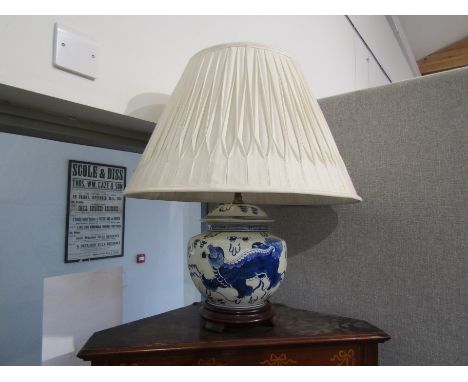 A blue and white Oriental-style electric table lamp base and shade