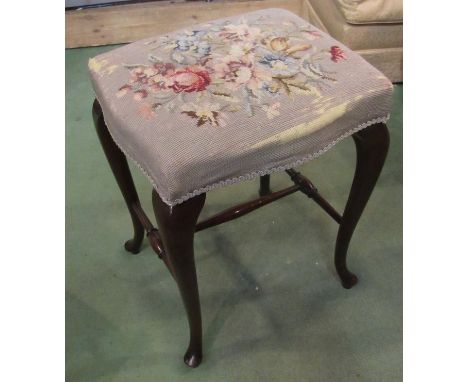 A 19th Century serpentine stool with tapestry upholstery, 55cm x 43cm