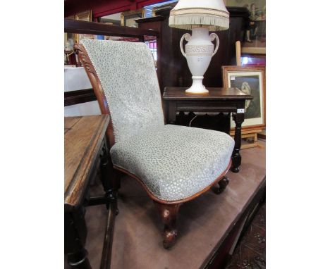 An early Victorian walnut nursery open armchair with carved acanthus leaf scroll back rest over carved cabriole legs and cera