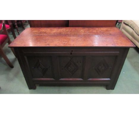 A 17th Century oak coffer, the rising lid over a carved three panel front on stile feet, with lidded internal candle box, 113