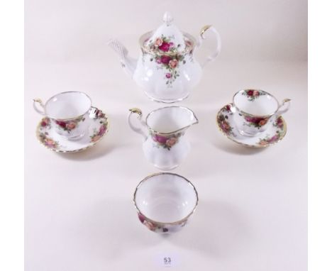 A Royal Albert Country Roses teaset comprising six cups and saucers, jug, sugar, two cake plates, six tea plates and teapot