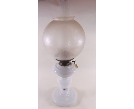A Victorian opaque glass oil lamp with etched shade and two funnels