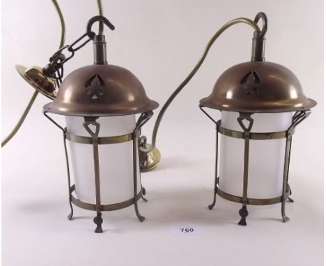 A pair of Arts & Crafts brass small lantern style light fittings with pierced decoration and glass liners