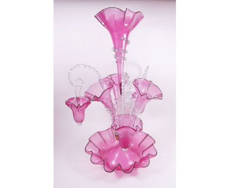 A Victorian cranberry glass epergne with central flute, three further flutes and three baskets - complete 