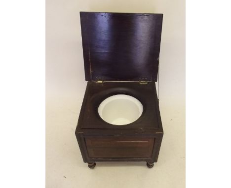 A Victorian stained wood rise top commode 