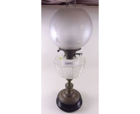 A Victorian brass oil lamp with cut glass reservoir and etched glass shade 