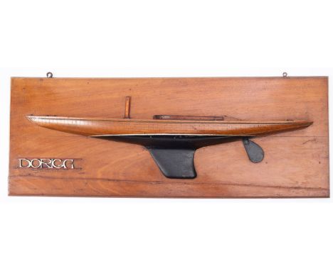 A half block model of the yacht 'Dorigo',  with main mast and cabin over simulated plank and pinned hull painted black beneat