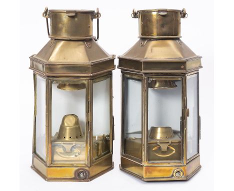 A matched pair of WWI period bulkhead engine room lamps, with glass panels and  original burners with key adjustment, swing h