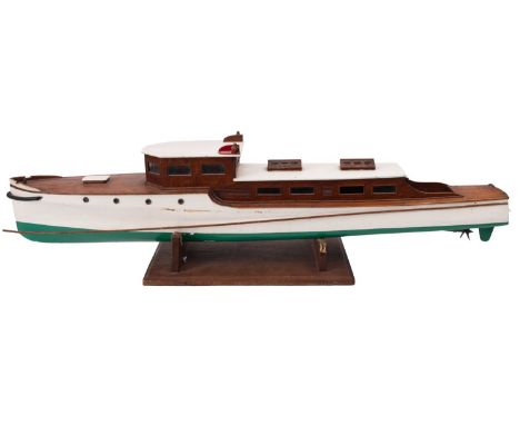 A  scale model of an early 20th century motor yacht , the white roof cabin with port/starboard lanterns over  simulated plank