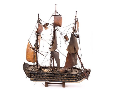 A scratch built model of HMS 'Victory' fully rigged over painted block hull with open ports and guns, 62x75cm.