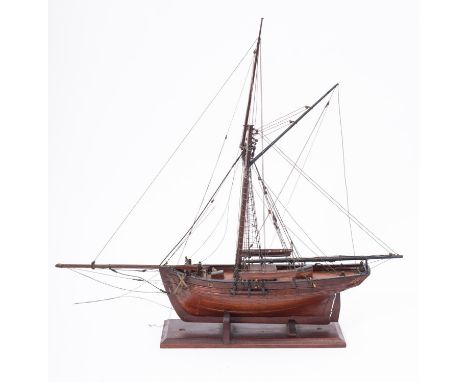 A scale model of an HM Revenue cutter, standing and running rigged over a simulated plank deck with gun ports and guns over a