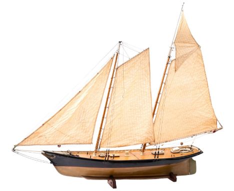 A scale model of the Americas Cup Racing Yacht  'America', fully rigged over simulated plank deck with fittings, the hull pai