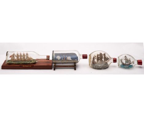 Four various model ships in bottles, comprising 'Kopenhagen', 'Stana Maria', a Barque, and one other.