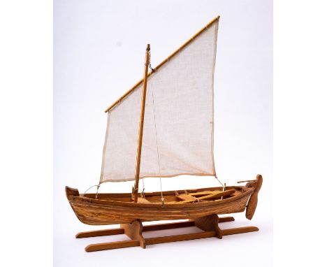 A scale model of a lugger boat 'Astrid' set sail over  planked  hull, raised on a wooden cradle, 41cm long, 42cm high