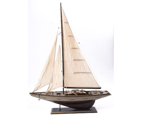 A scale model of a yacht, fully rigged over deck with fittings, the hull painted white to waterline and red beneath, 77 x 100