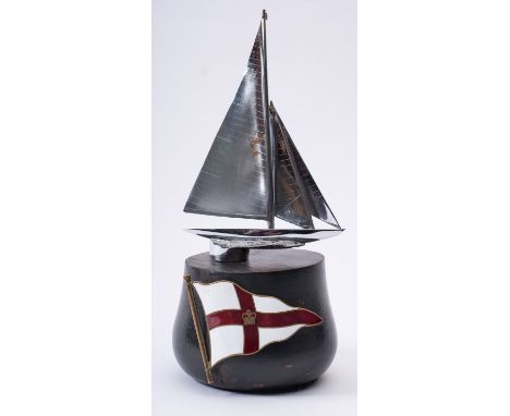 A Royal Yacht Squadron enamel badge, mounted  on an ebony socle with a silver plated model of a J-class yacht 'Endevour' (JK4
