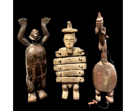 THREE AFRICAN FIGURAL MUSICAL INSTRUMENTS, including standing mbira and standing harp, and another, tallest 67cm h (3)
Commen