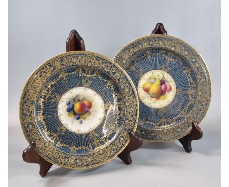 Two similar Royal Worcester dessert dishes/plates, hand painted with fruits and foliage by A Shuck, one with puce printed mar