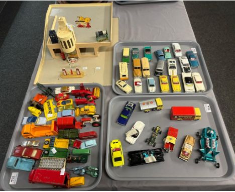 Toy car model of a 1950s petrol station together with three trays of playworn diecast model vehicles to include: Budgie, Dink