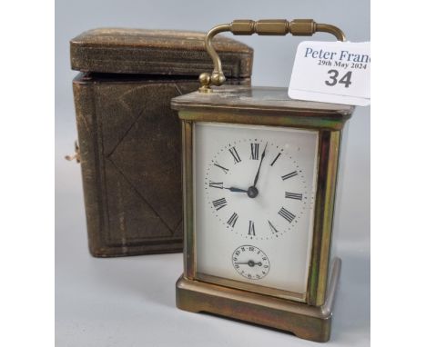 Early 20th century French brass carriage clock with alarm movement and full depth Roman face, together with original leather 