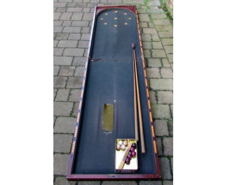 Early 20th century mahogany folding bagatelle board with cues and balls