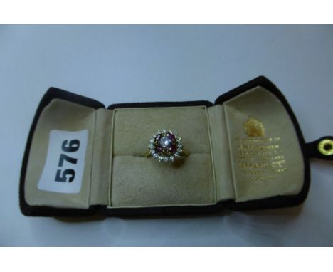 A fine Garrard &amp; Co. 18ct gold, ruby and diamond cluster ring,London c.1975, the centre brilliant cut diamond above four 