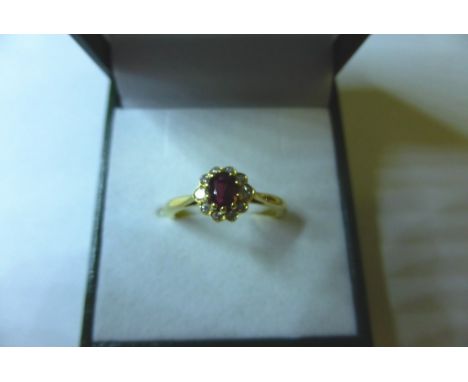 An 18ct yellow gold, ruby and diamond cluster ring (size M)