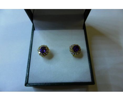 A pair of 18ct yellow gold, amethyst and diamond cluster stud earrings