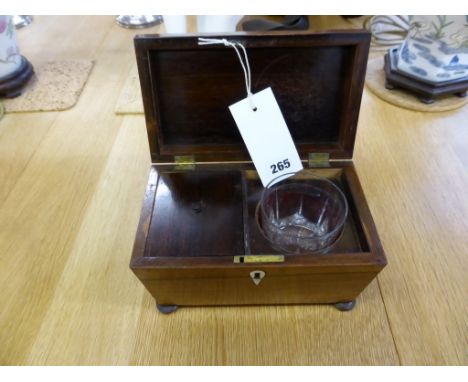 A George IV rosewood tea caddy,sarcophagus form, the interior with single lidded compartment and replaced glass bowl, on turn