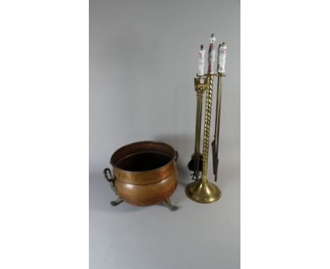 A Copper Coal Bucket with Claw Feet and Brass Handles, Together with a Ceramic Handled Brass Companion Set
