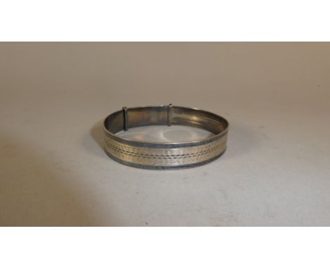 A Silver Bangle with Engine Turned Decoration 