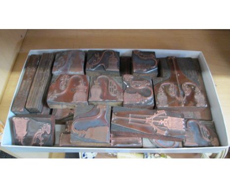 A collection of printers engraved copper plate printing blocks, showing vintage lighting