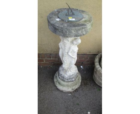 A reconstituted stone sundial, the column cast as the Three Graces