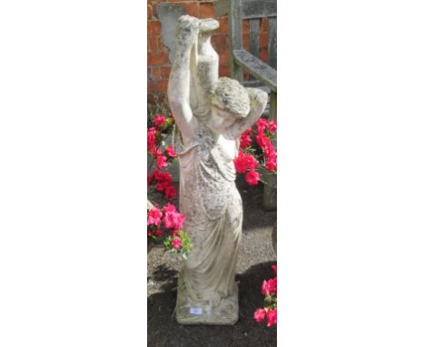 A reconstituted stone garden statue, cast as a classically attired maiden carrying a water vessel