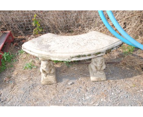 Curved garden bench standing on squirrel columns.