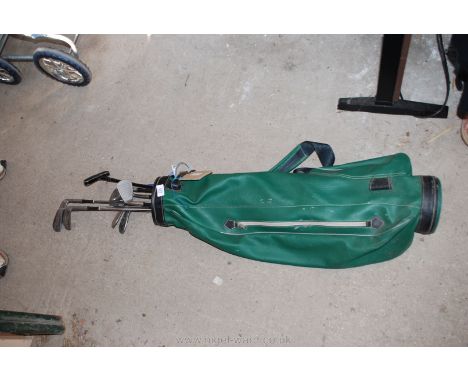 Part set of golf clubs and caddy bag.