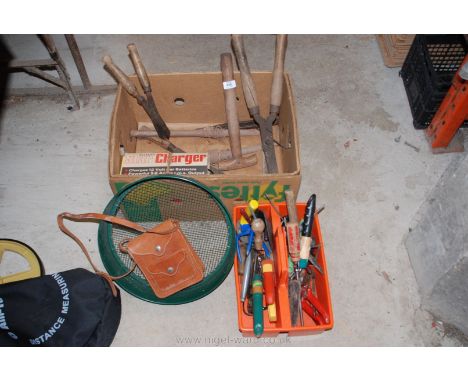 Box of gardening hand tools, battery charger and bill hook.