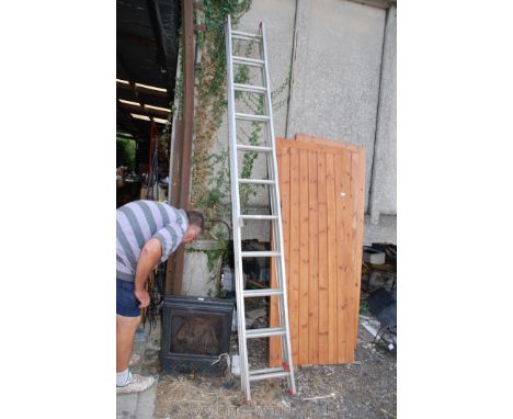 Eleven rung double aluminium extension ladder.