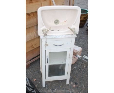 Glazed fronted bathroom cabinet and hand basin.