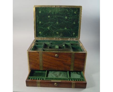 A mahogany and brass bound vanity travelling case, early/mid 19th century, with lifting lid to reveal trays and storage for b