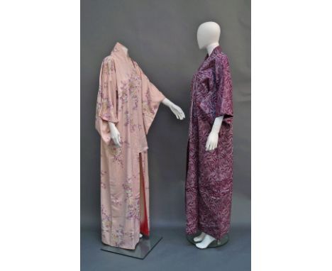 A Japanese kimono, mid 20th century, floral sprays on a pink ground, together with another, latter 20th century, in a purple 