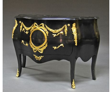 A French style ebonised wood and gilt decorated bombe commode, 20th century, in the 18th century style, with wreath and swag 